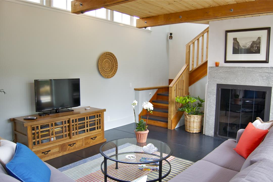 228 Kelly Avenue Half Moon Bay, CA 94019 - Photo 6 of 29 a living room with furniture and a flat screen tv