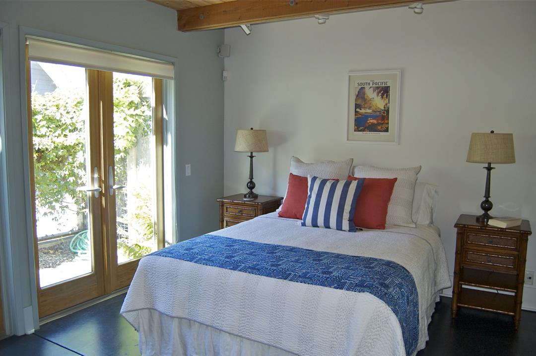 228 Kelly Avenue Half Moon Bay, CA 94019 - Photo 9 of 29 a bed sitting in a bedroom next to a window