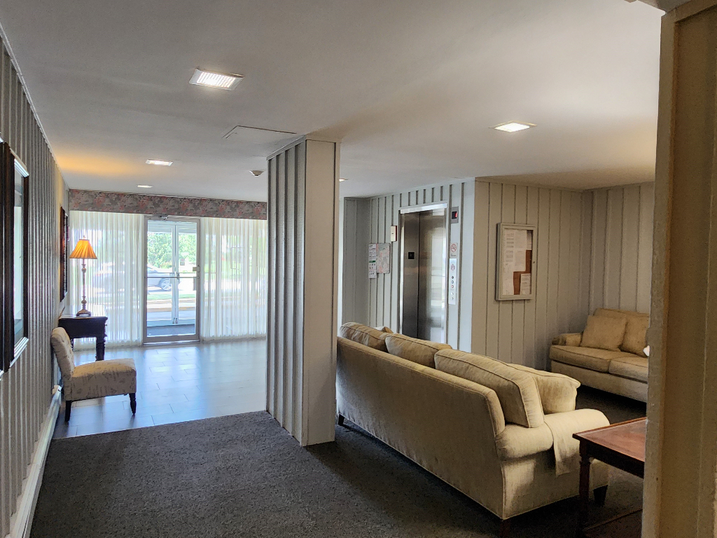 1133 South Finley Road, Unit 404 Lombard, IL 60148 - Photo 13 of 18 a living room with furniture and a large window