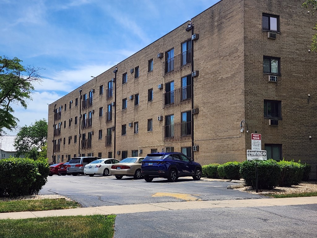 1133 South Finley Road, Unit 404 Lombard, IL 60148 - Photo 18 of 18 a car parked in front of brick building
