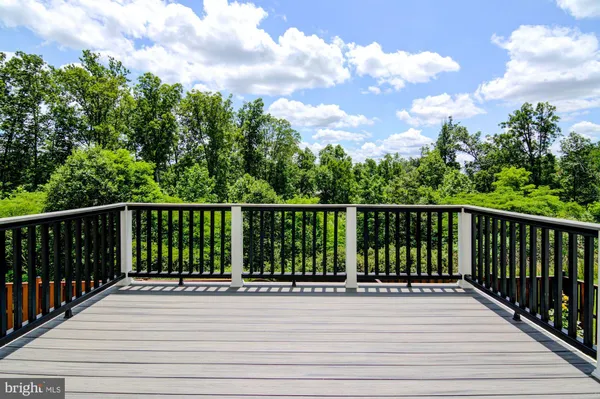 a view of balcony with wooden floor and fence