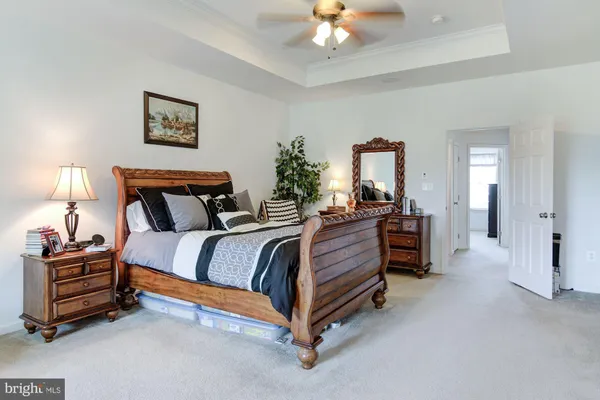 a spacious bedroom with a bed and a lamp