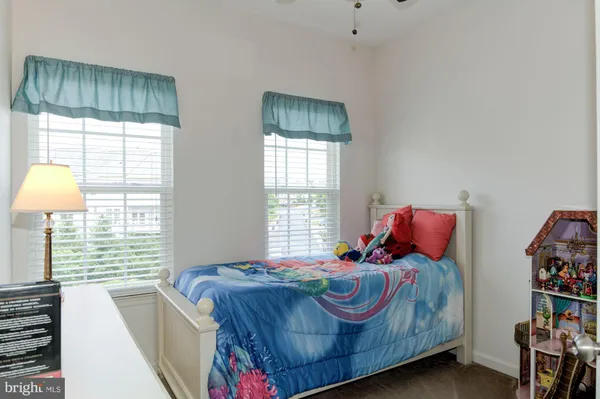 a bed sitting in a bedroom next to a window