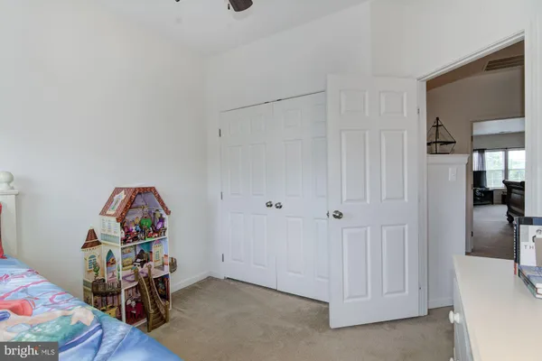 a view of a room that has a bed and a closet in it