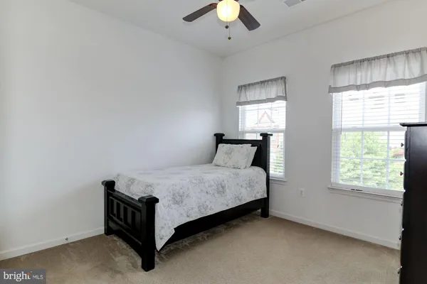 a spacious bedroom with a bed and window
