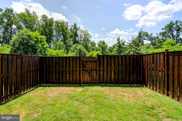 a view of yard with wooden fence