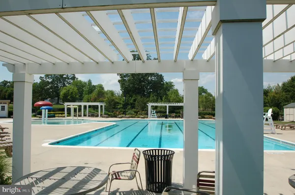 a view of a swimming pool with seating space