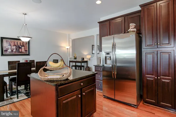 a kitchen with stainless steel appliances granite countertop a refrigerator and a stove