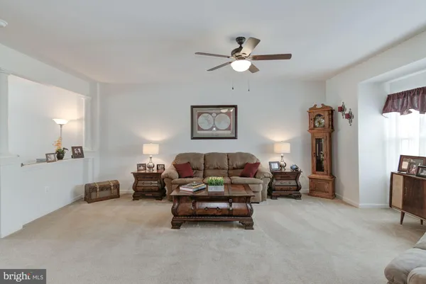 a living room with furniture and a lamp