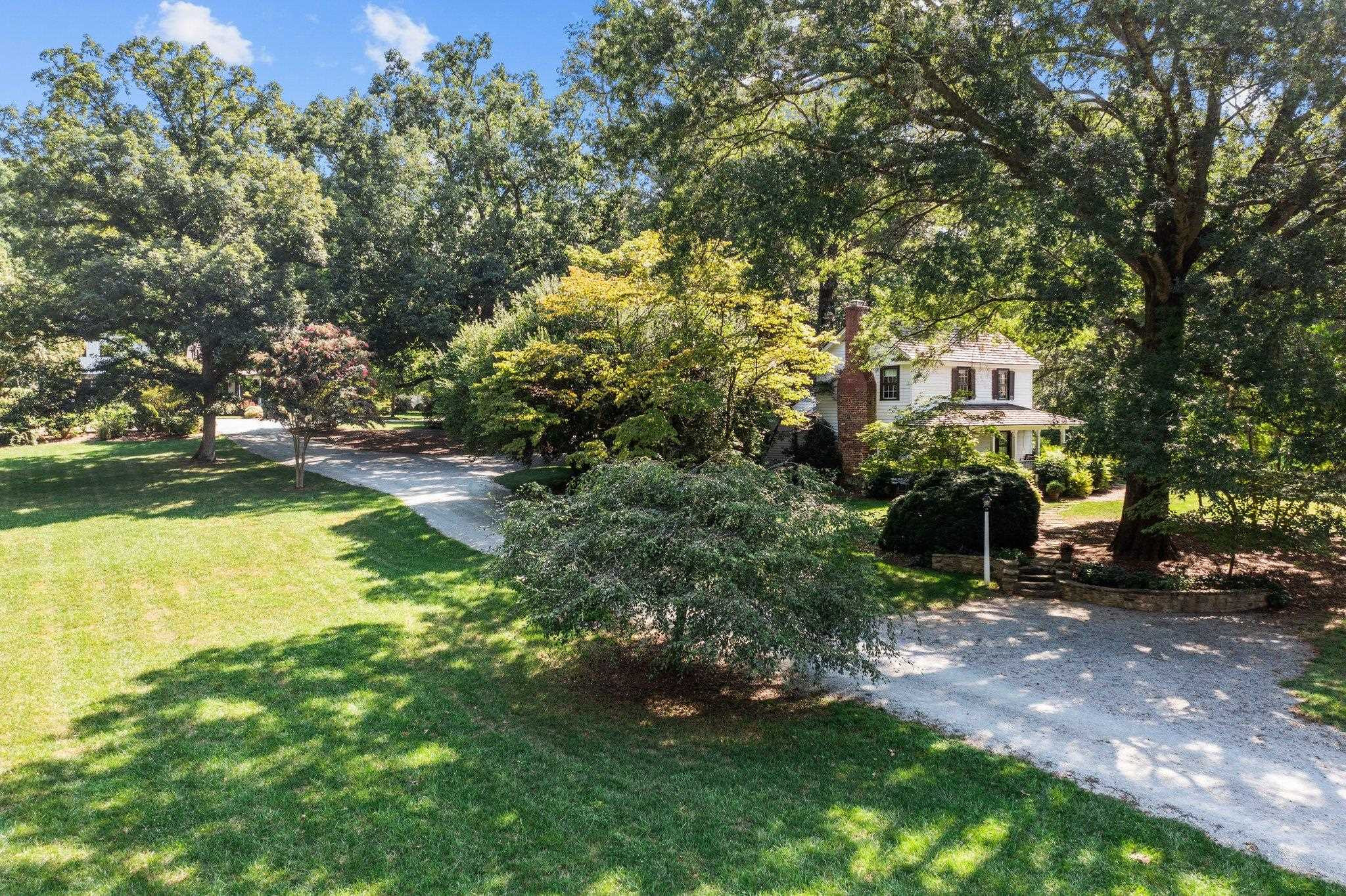 4900 West Cornwallis Road Durham, NC 27705 - Photo 12 of 100 a view of a house with a yard and sitting area