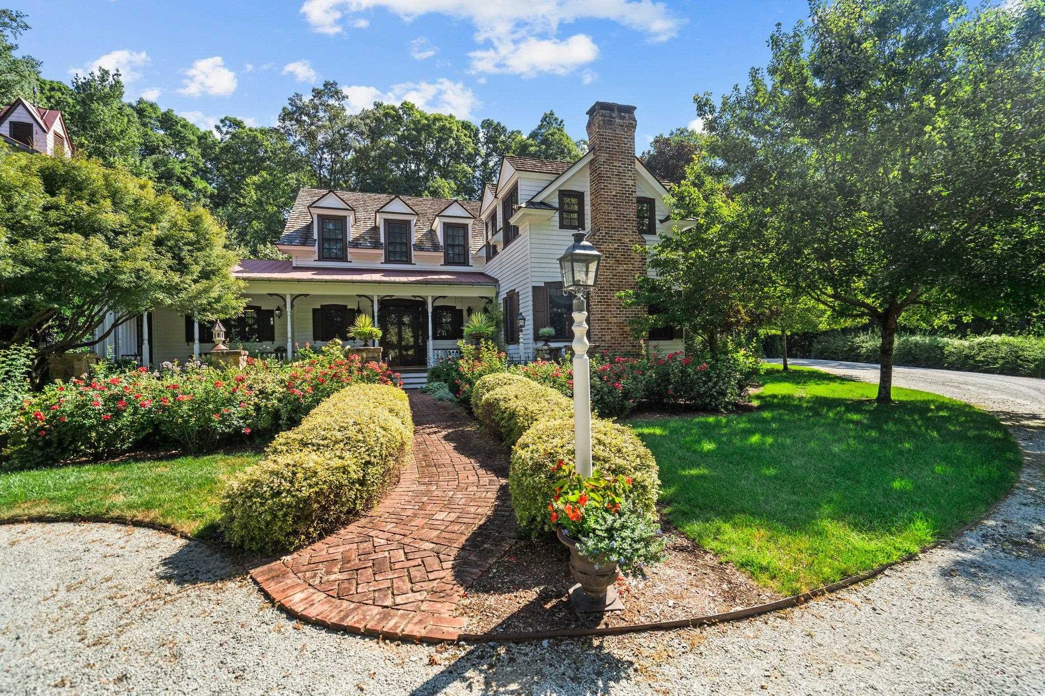 4900 West Cornwallis Road Durham, NC 27705 - Photo 13 of 100 a front view of a house with a yard table and chairs
