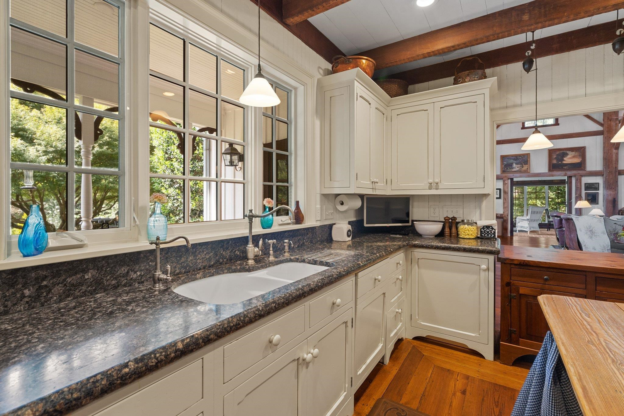 4900 West Cornwallis Road Durham, NC 27705 - Photo 37 of 100 a kitchen with granite countertop a sink and a counter top space