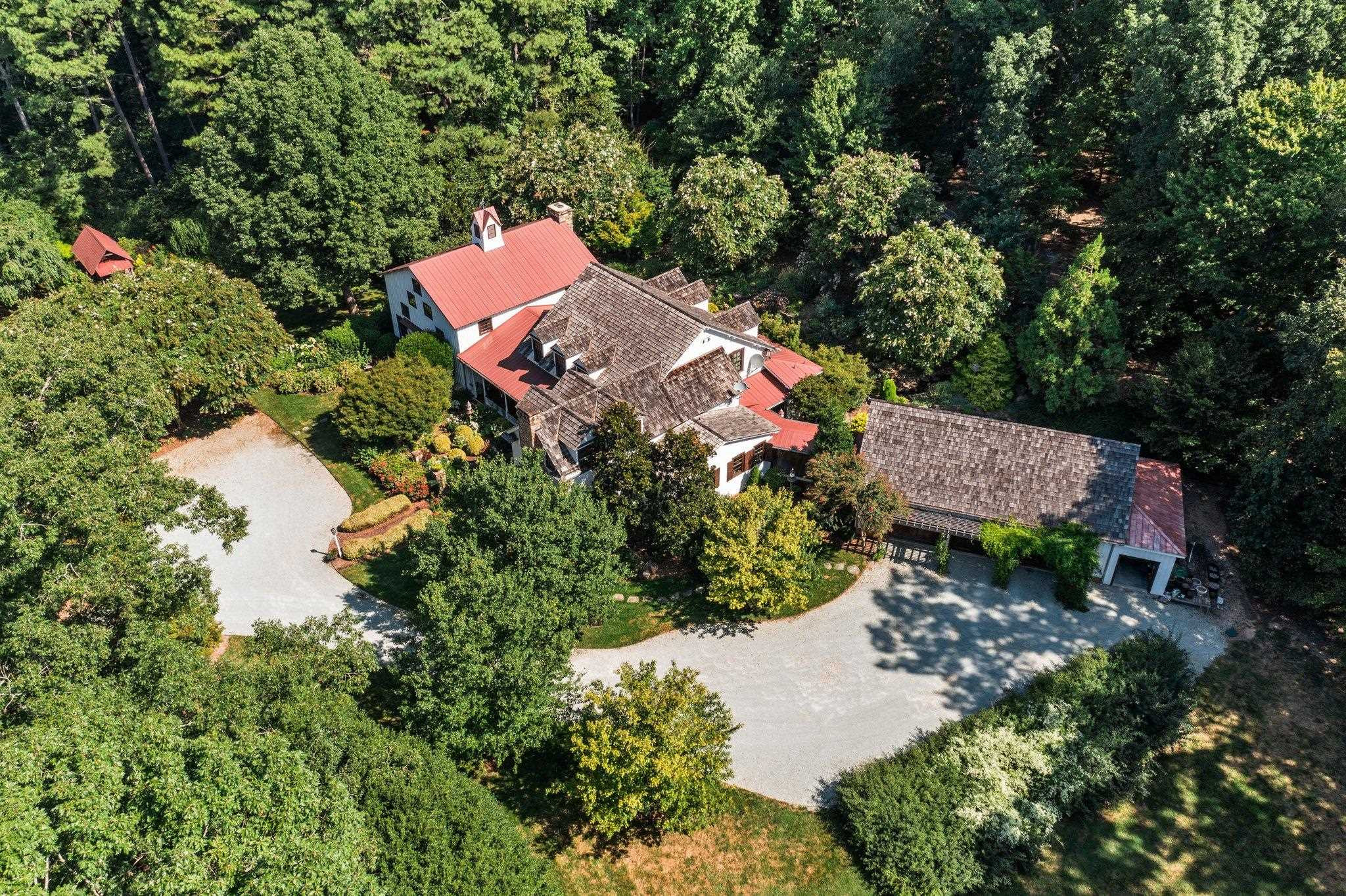 4900 West Cornwallis Road Durham, NC 27705 - Photo 6 of 100 an aerial view of a house with a yard and a large tree