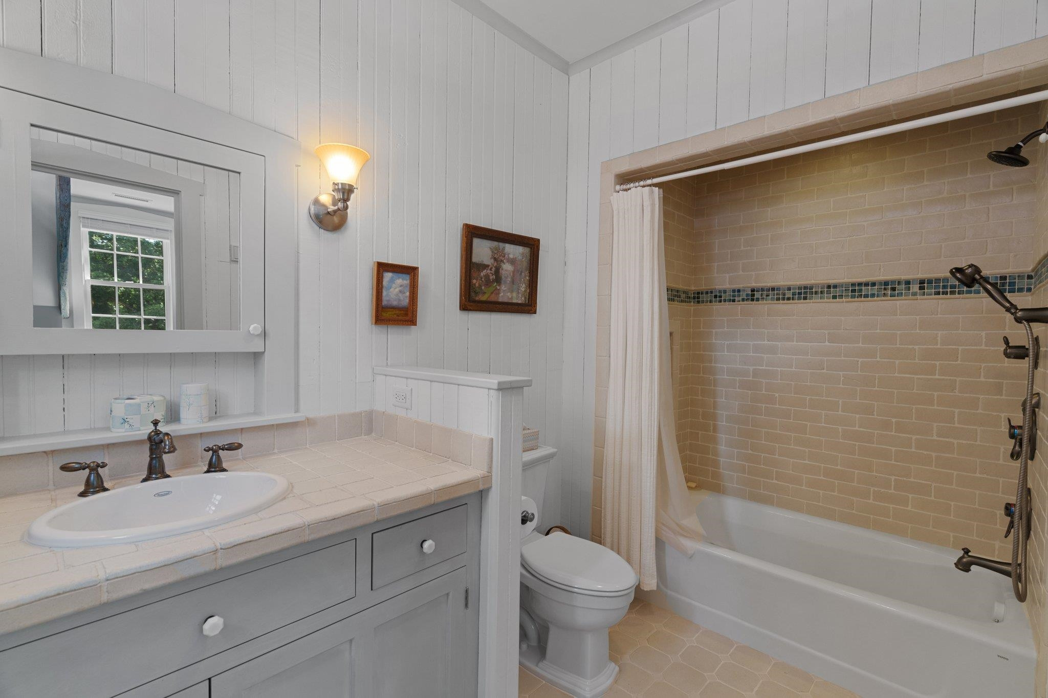 4900 West Cornwallis Road Durham, NC 27705 - Photo 74 of 100 a bathroom with a sink toilet and shower