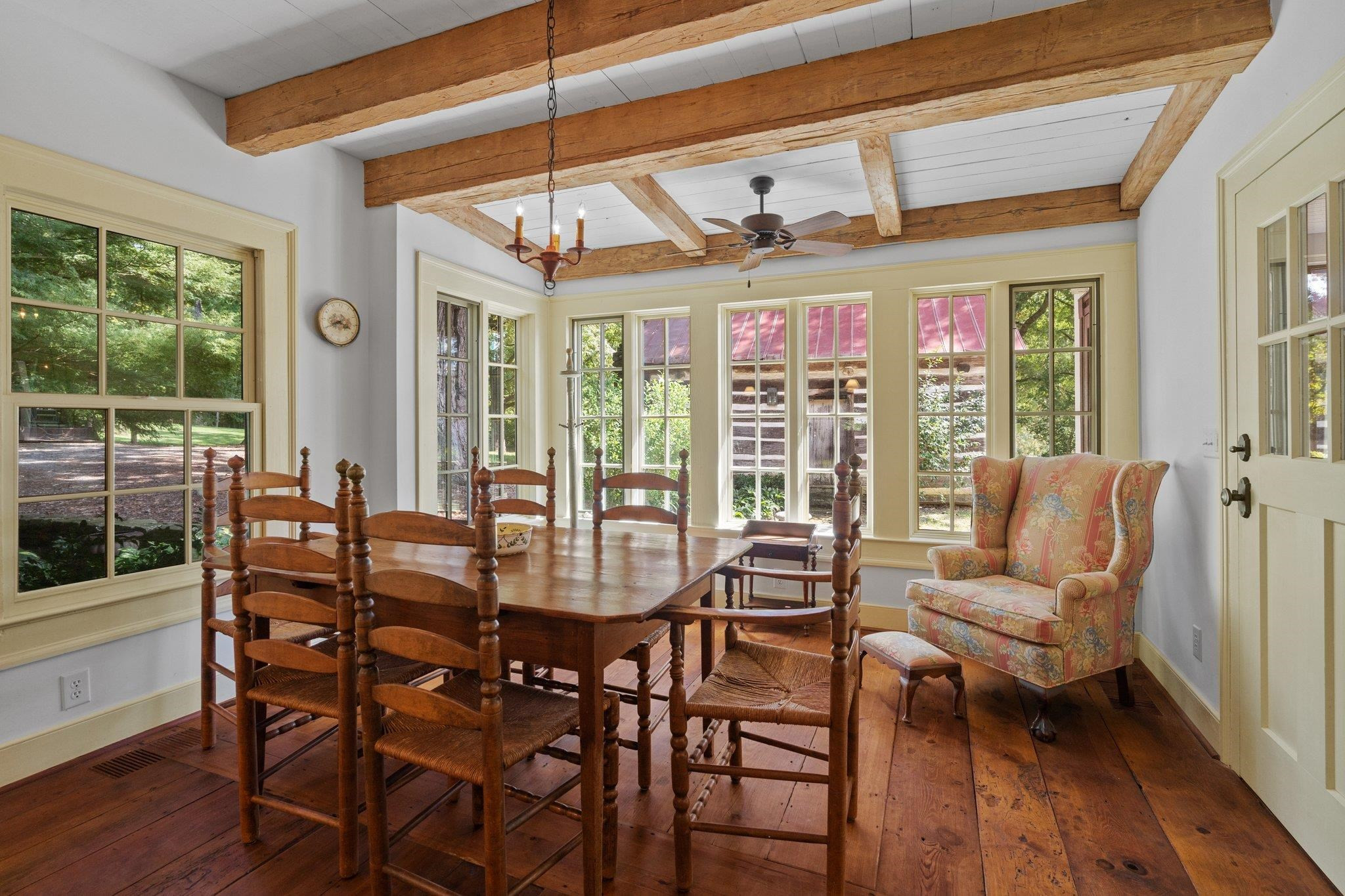 4900 West Cornwallis Road Durham, NC 27705 - Photo 79 of 100 a view of a dining room with furniture large windows and wooden floor