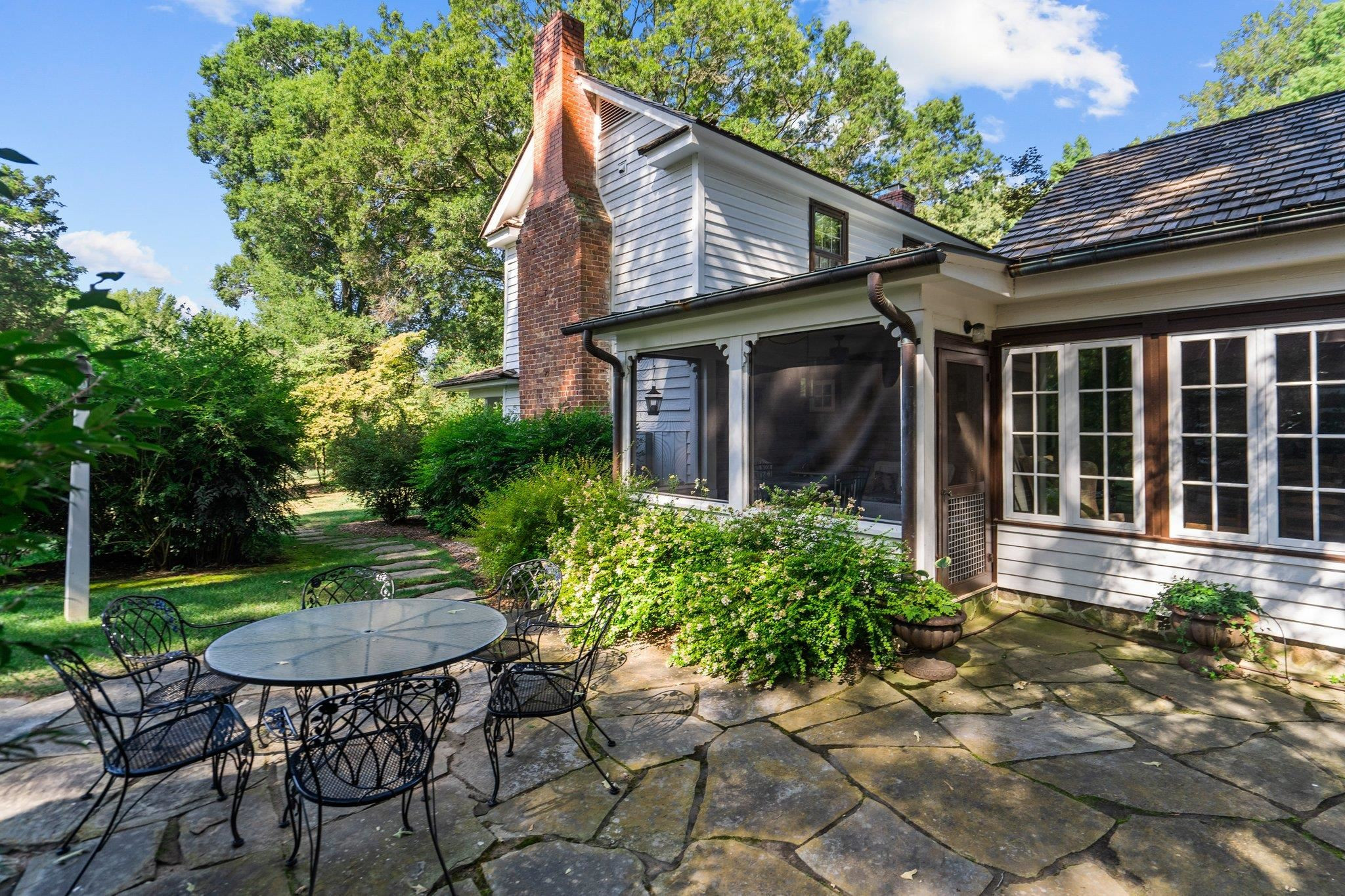 4900 West Cornwallis Road Durham, NC 27705 - Photo 85 of 100 a view of a chair and table in backyard of the house