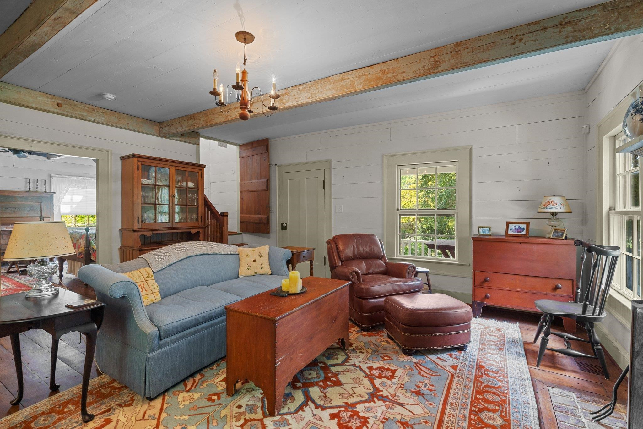 4900 West Cornwallis Road Durham, NC 27705 - Photo 88 of 100 a living room with furniture a chandelier and a window