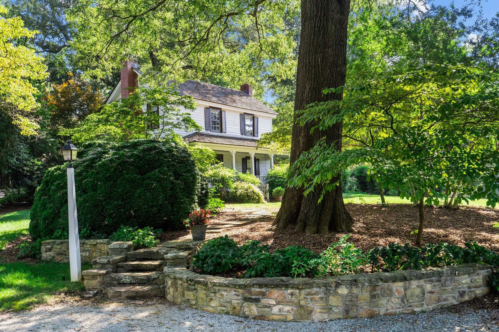 4900 West Cornwallis Road Durham, NC 27705 - Photo 10 of 100 a front view of a house with garden
