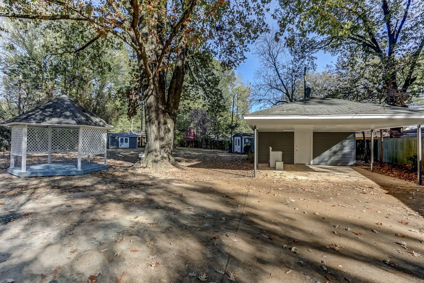 4518 Garnett Road Memphis, TN 38117 - Photo 18 of 22 a view of house with outdoor seating and covered with trees