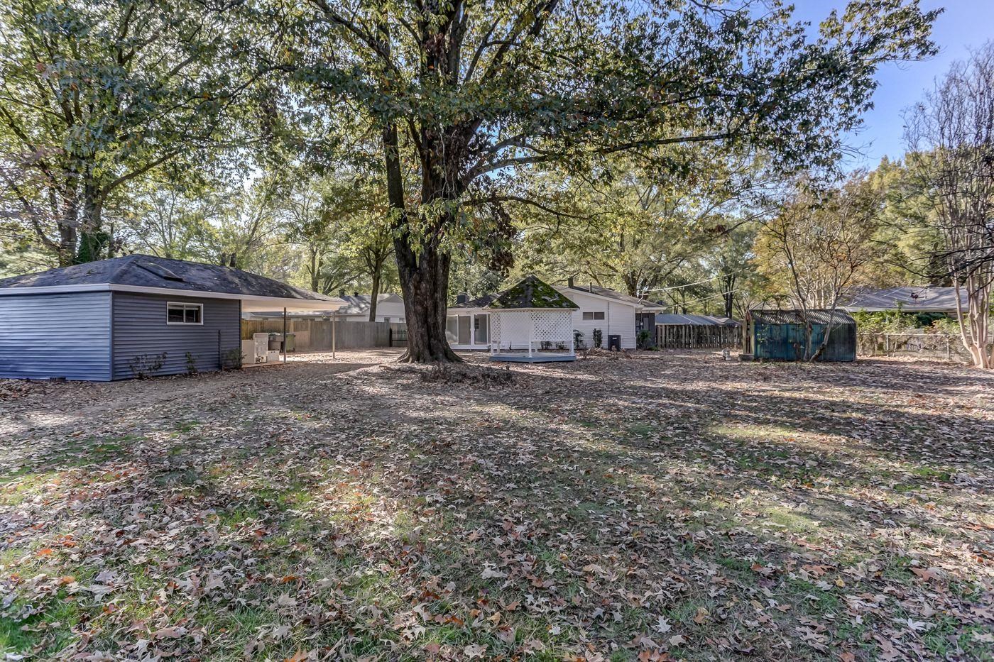 4518 Garnett Road Memphis, TN 38117 - Photo 21 of 22 a view of a house with a yard and tree s