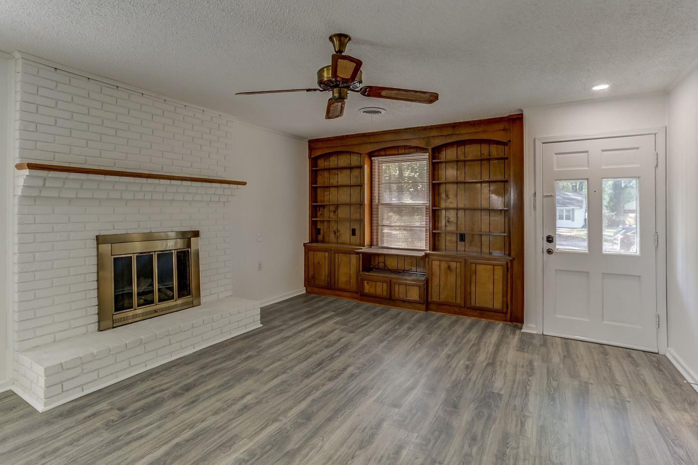 4518 Garnett Road Memphis, TN 38117 - Photo 3 of 22 a view of a livingroom with wooden floor a ceiling fan and windows