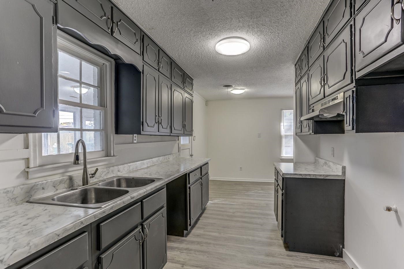 4518 Garnett Road Memphis, TN 38117 - Photo 5 of 22 a kitchen with stainless steel appliances granite countertop a sink and a microwave