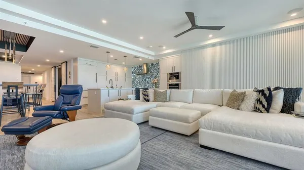 a living room with furniture and a large mirror