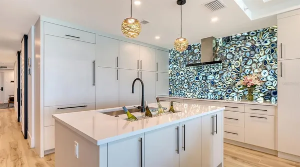 a kitchen with a sink a counter and cabinets
