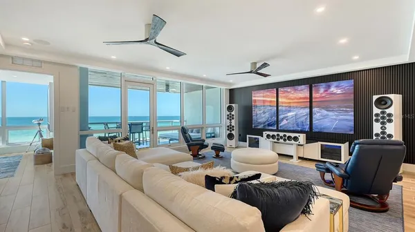a living room with furniture and large windows