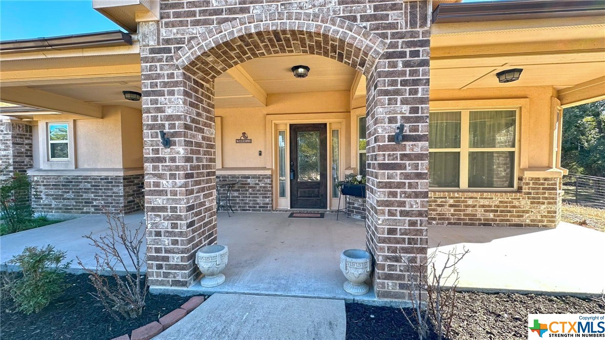 view of brick building with a outdoor space