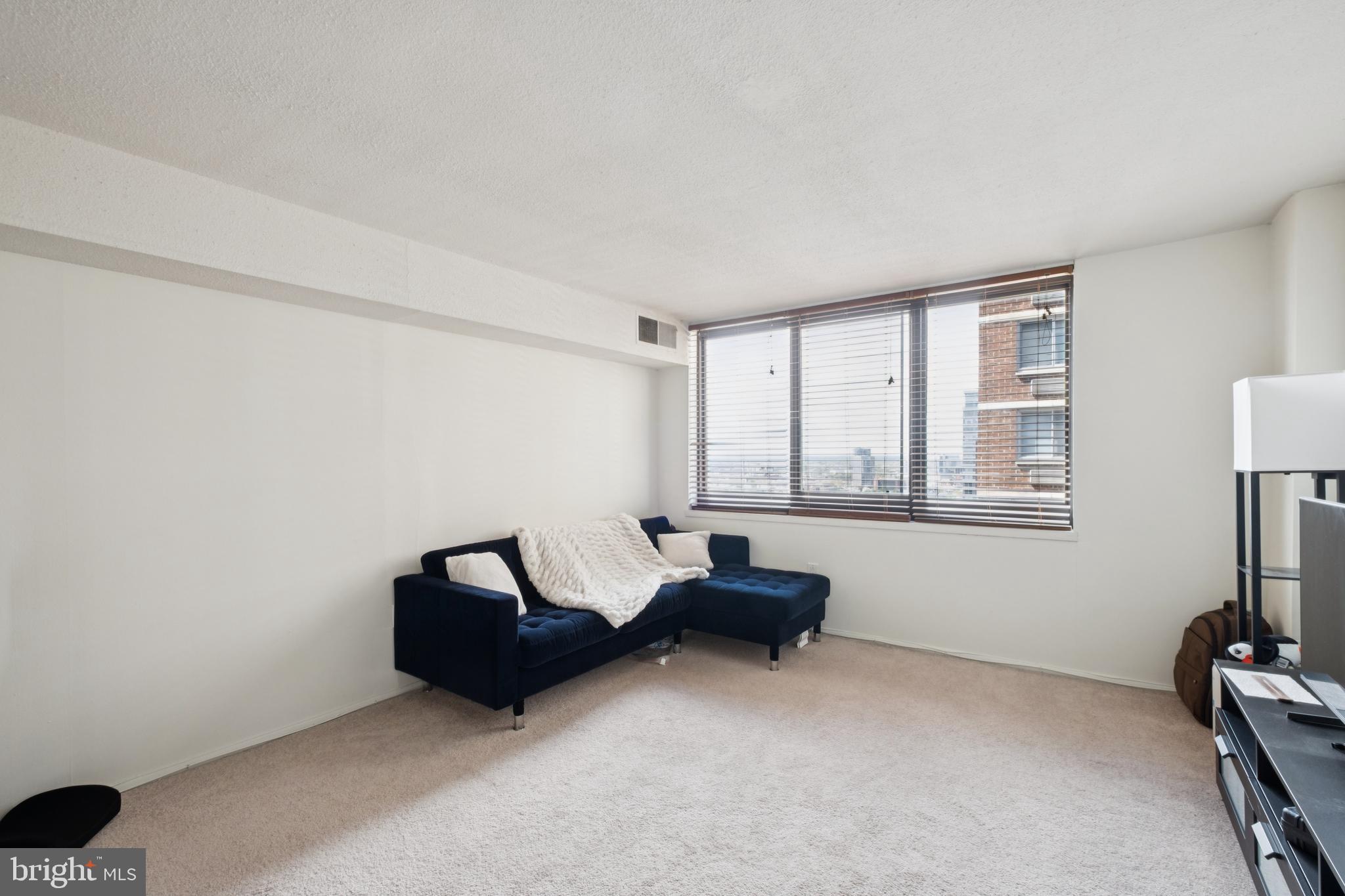 1420 Locust Street, Unit 31H Philadelphia, PA 19102 - Photo 1 of 15 a living room with furniture and a window