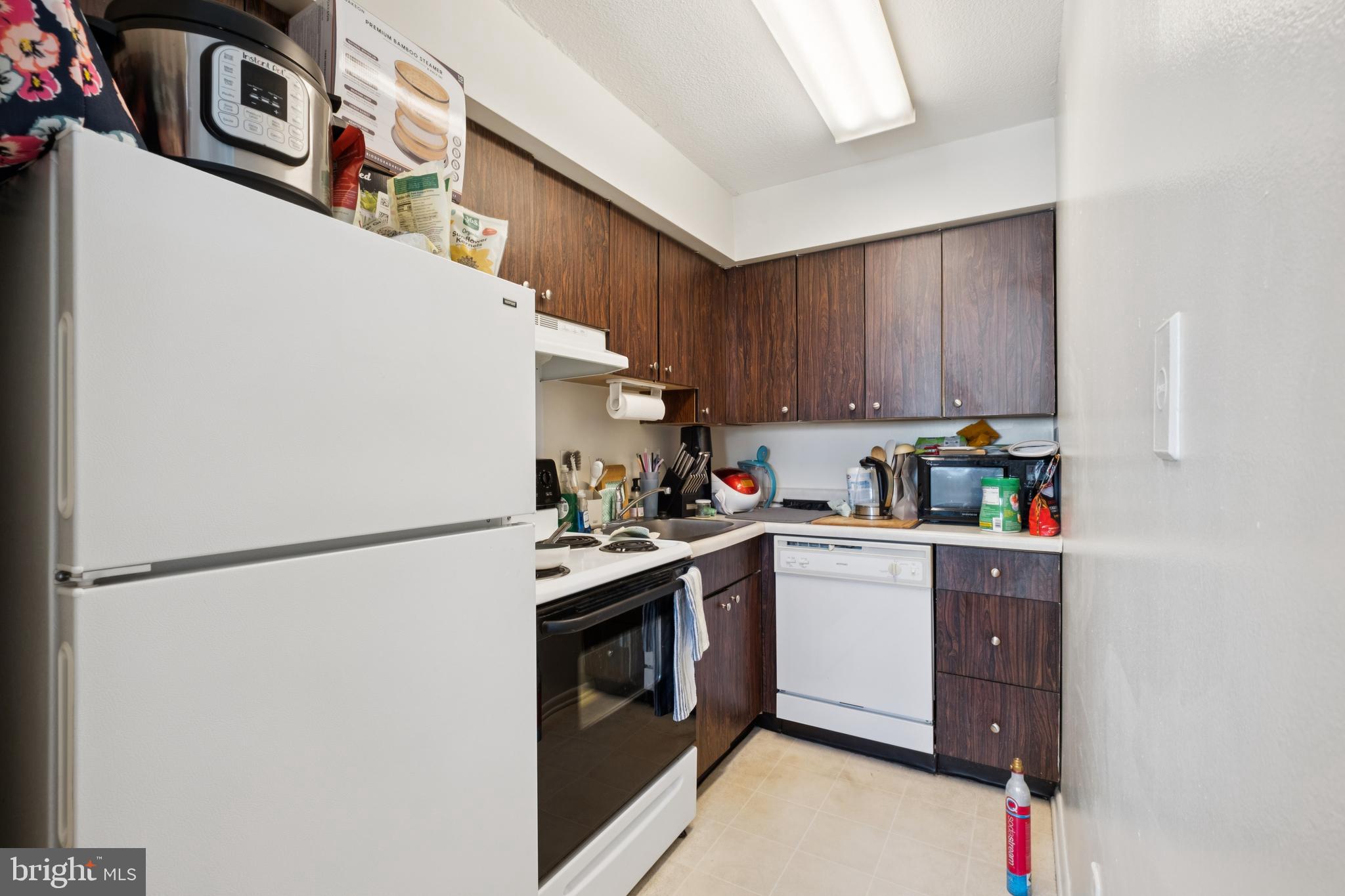 1420 Locust Street, Unit 31H Philadelphia, PA 19102 - Photo 2 of 15 a kitchen with stainless steel appliances granite countertop a refrigerator a stove a sink and a refrigerator