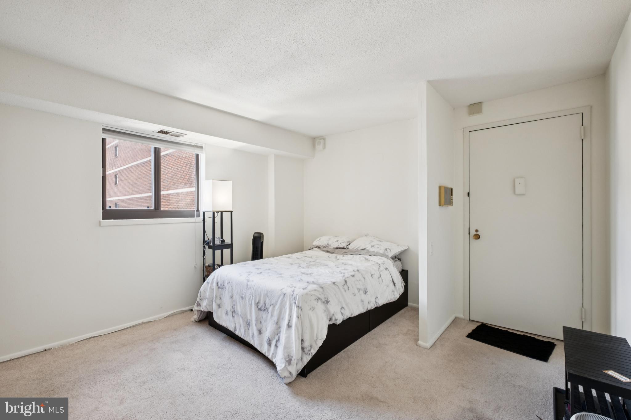 1420 Locust Street, Unit 31H Philadelphia, PA 19102 - Photo 3 of 15 a bedroom with a bed and a window