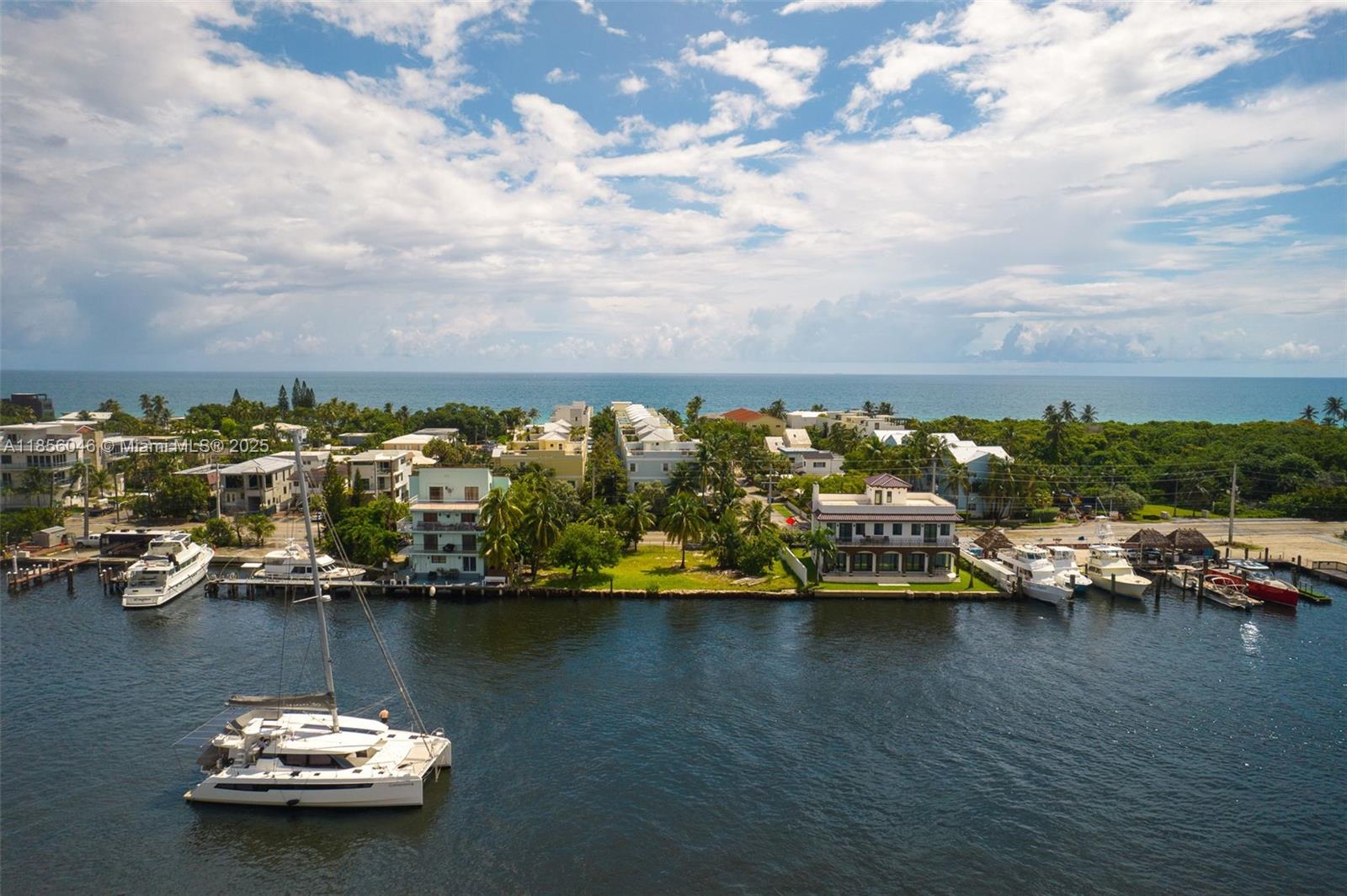 an aerial view of a houses with ocean view