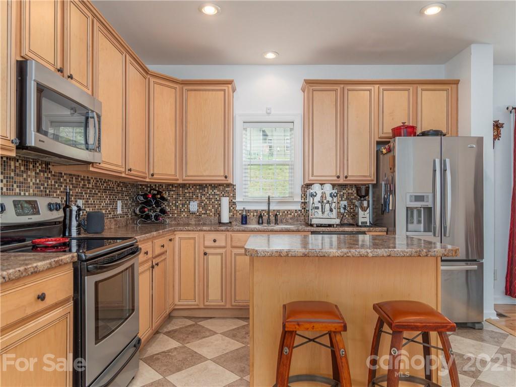56 Porters Ridge Canton, NC 28716 - Photo 14 of 32 a kitchen with stainless steel appliances white cabinets and a stove top oven