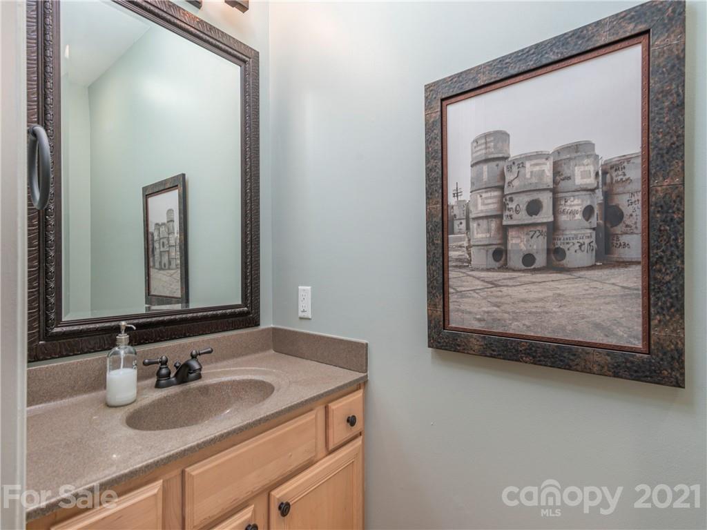 56 Porters Ridge Canton, NC 28716 - Photo 18 of 32 a bathroom with a granite countertop sink and a mirror