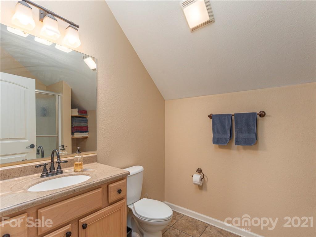 56 Porters Ridge Canton, NC 28716 - Photo 25 of 32 a bathroom with a toilet a sink and mirror