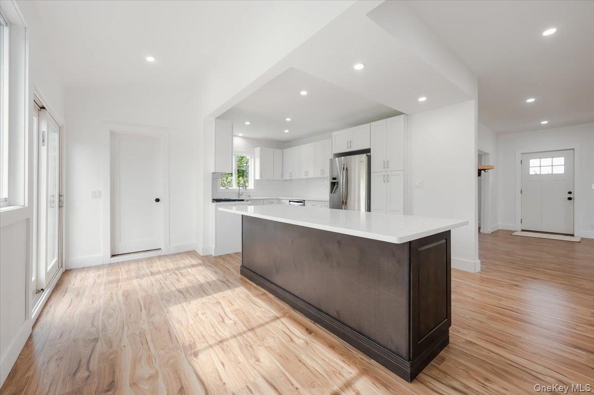 56 Oak Beach Road Babylon, NY 11702 - Photo 11 of 30 Newly remodeled kitchen shines with a oversized center island with quartz countertops and stainless steel appliances.