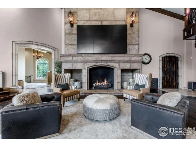 a living room with fireplace furniture and a flat screen tv
