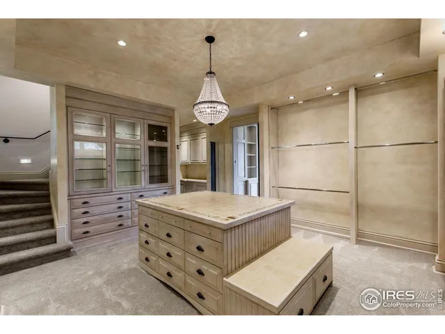 a spacious bedroom with a bed and a chandelier