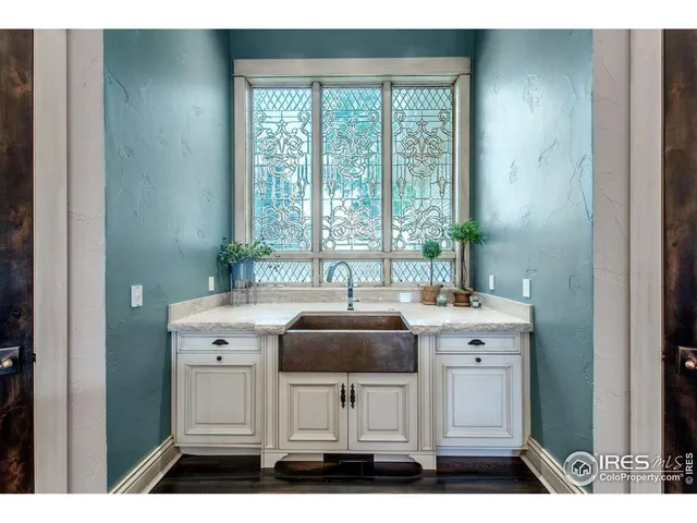 a dining room with furniture wooden floor and a chandelier
