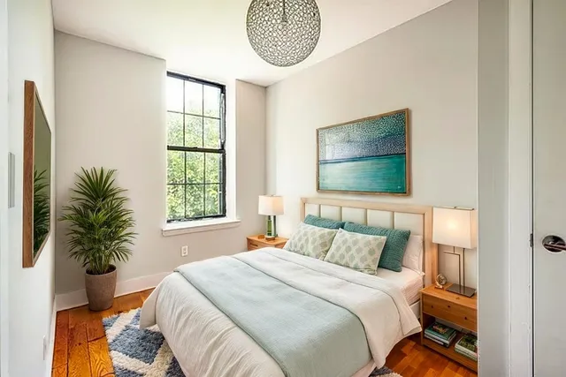 a bedroom with a bed and a window