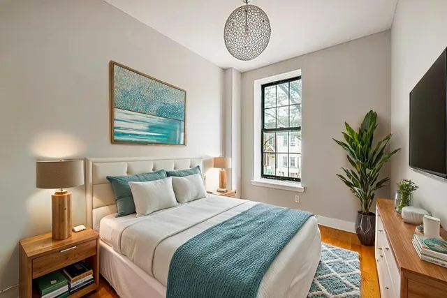 a bedroom with bed and a window