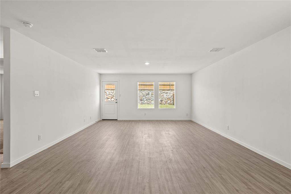 1138 Barbary Flds Street Forney, TX 75126 - Photo 6 of 25 Spacious interior room featuring wood-finish flooring, white walls, and recessed lighting