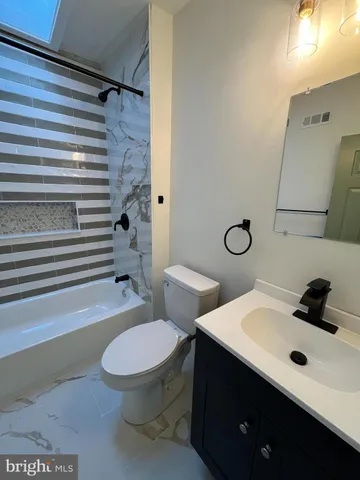a bathroom with a sink a toilet and shower curtain