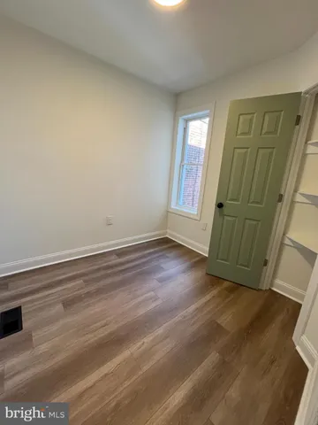 a view of a livingroom with wooden floor and window