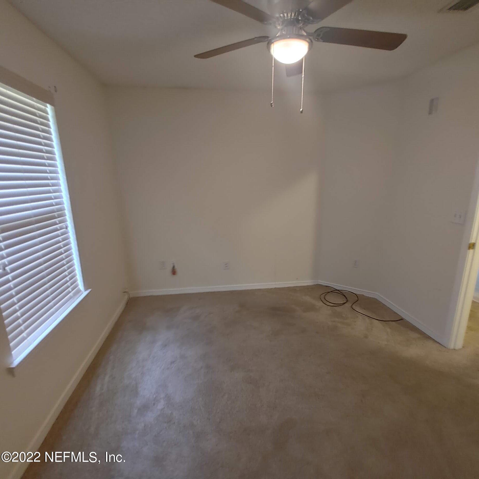 10346 Clayton Mill Road Jacksonville, FL 32221 - Photo 19 of 19 en empty room with windows and ceiling fan