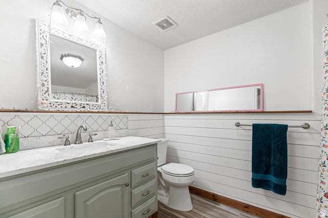 814 Mountain Road Logan, UT 84321 - Photo 26 of 42 Bathroom featuring a vanity with an integrated sink, brushed nickel faucet, and a decorative mirror