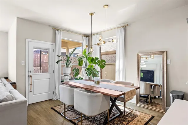 a dining room with furniture window and wooden floor