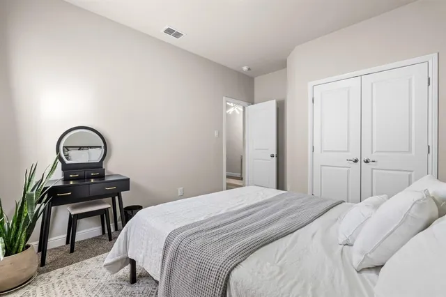 a bedroom with furniture and a window